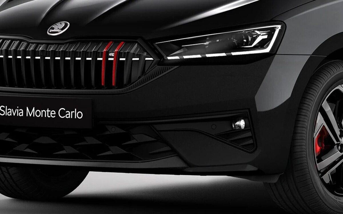 Close-up of the front of a black Skoda Slavia Monte Carlo, with red grille accents, LED headlamps and black alloys with red brake calipers