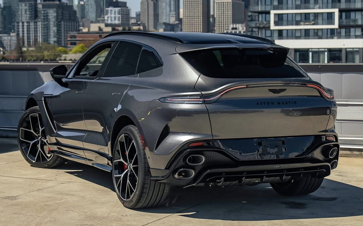 Grey Aston Martin DBX S parked in a city, rear three-quarter view