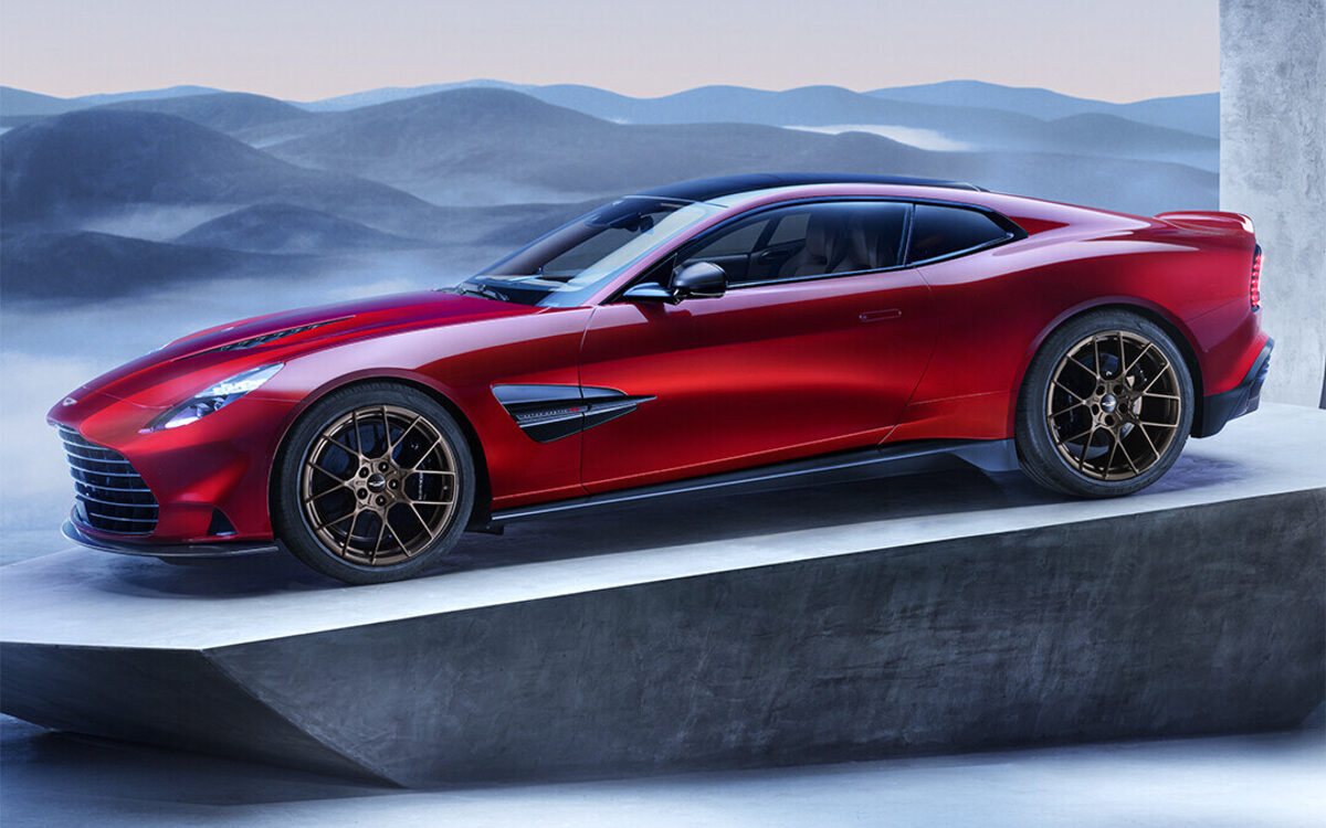 Red Aston Martin Vanquish on a stone plinth, side three-quarter view