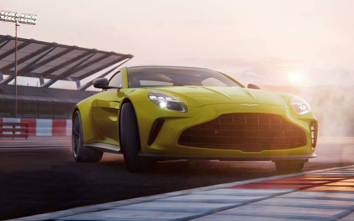 Yellow Aston Martin Vantage at a race track, front view