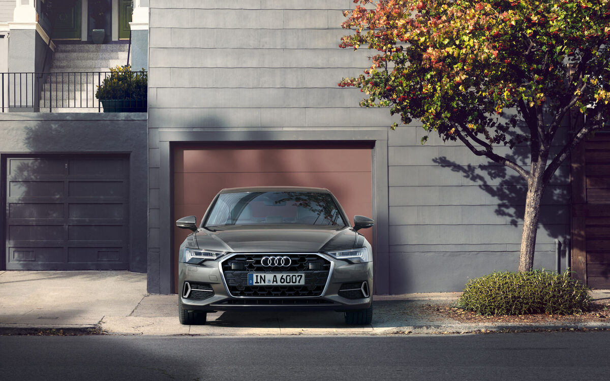 Audi A6 in Chronos Grey parked on a city street, seen head-on