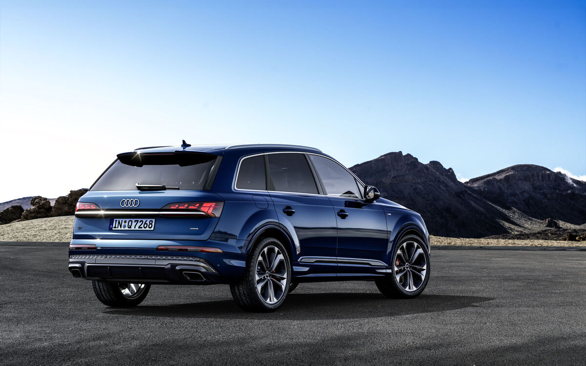 Audi Q7 in Ascari Blue, rear three-quarter view parked on tarmac
