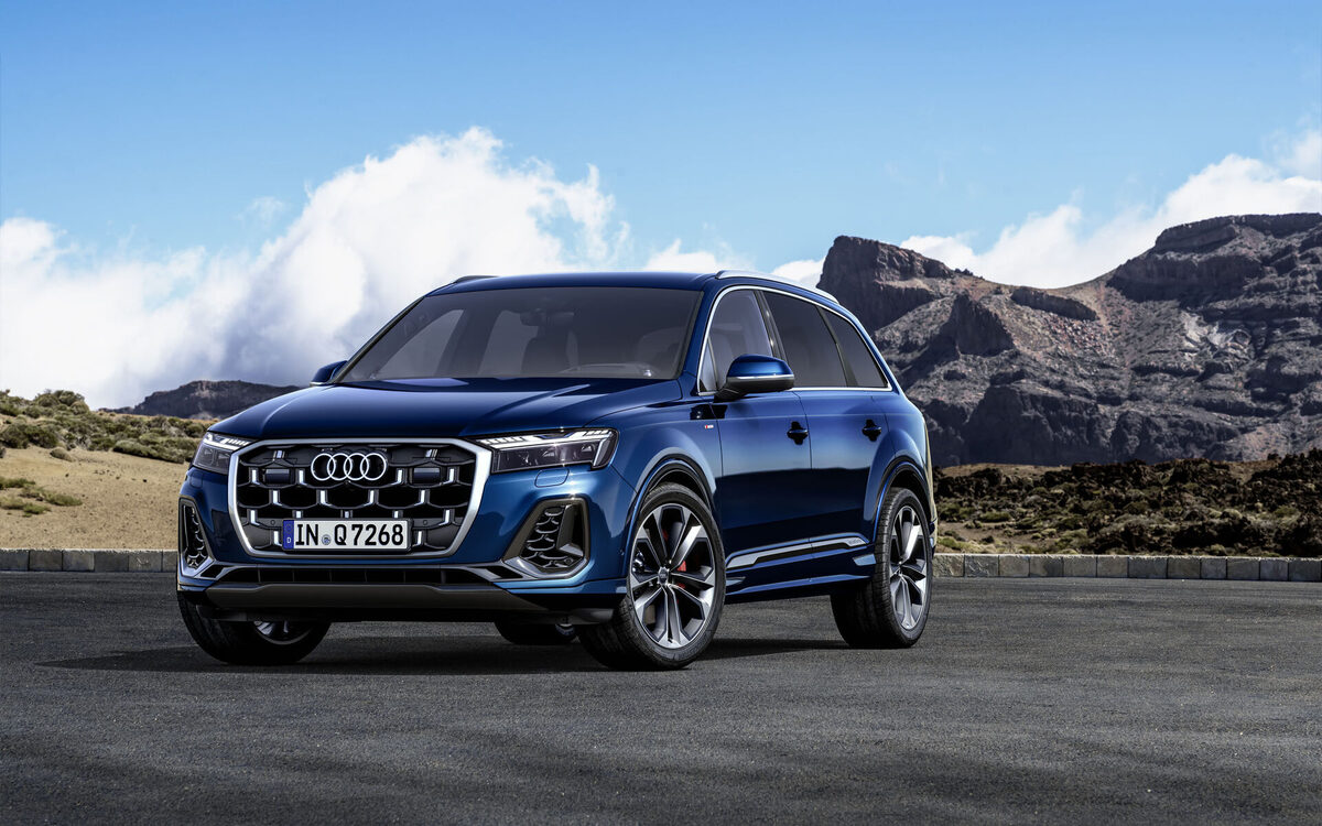 Audi Q7 in Ascari Blue, low front corner view showing the large grille and headlamps