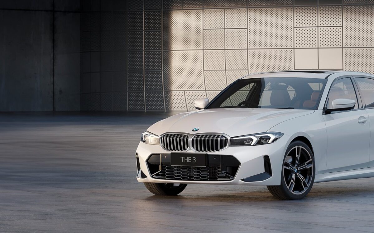 BMW 3 Series Long Wheelbase in white, front three-quarter view in a studio-style hall