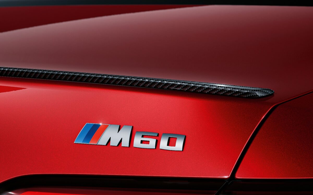 M60 badge and carbon boot spoiler on the rear of the red BMW i5