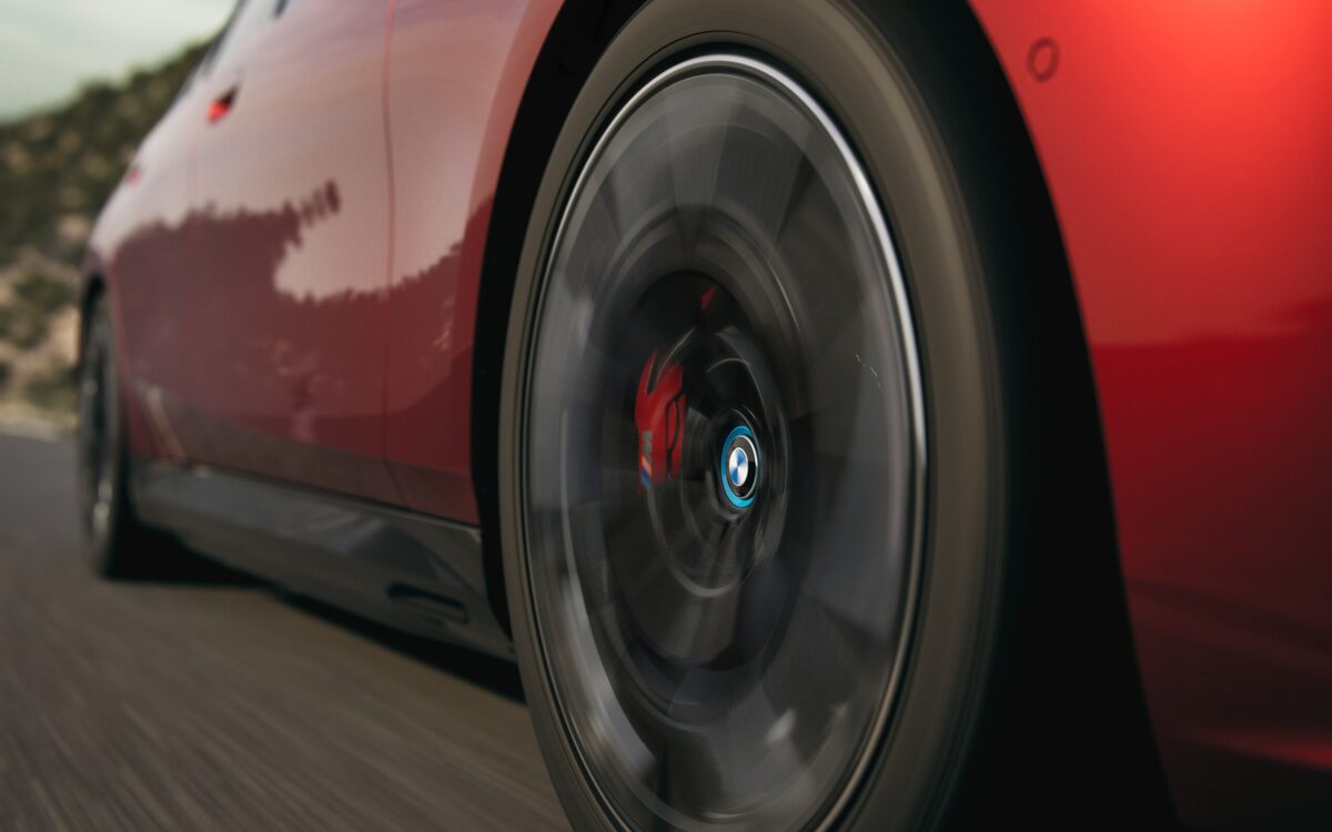 Red BMW i5 M60 wheel and brake caliper while driving