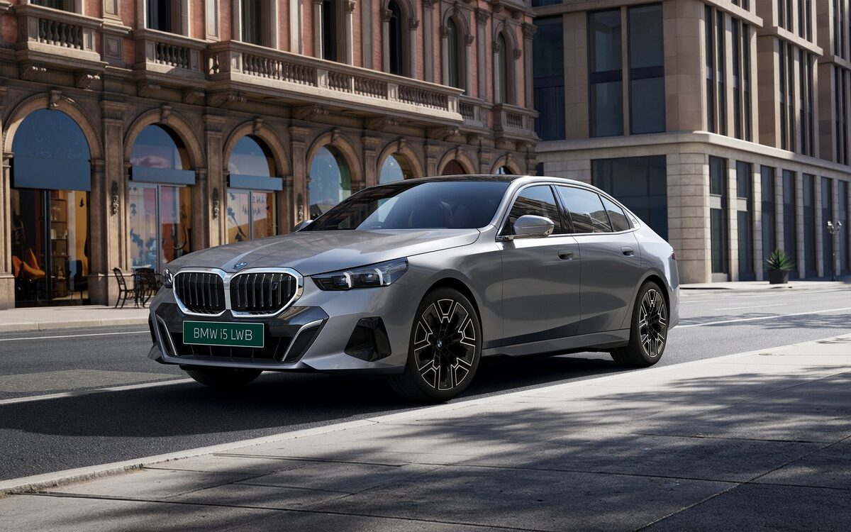 BMW i5 LWB in silver, front three-quarter view on a city street