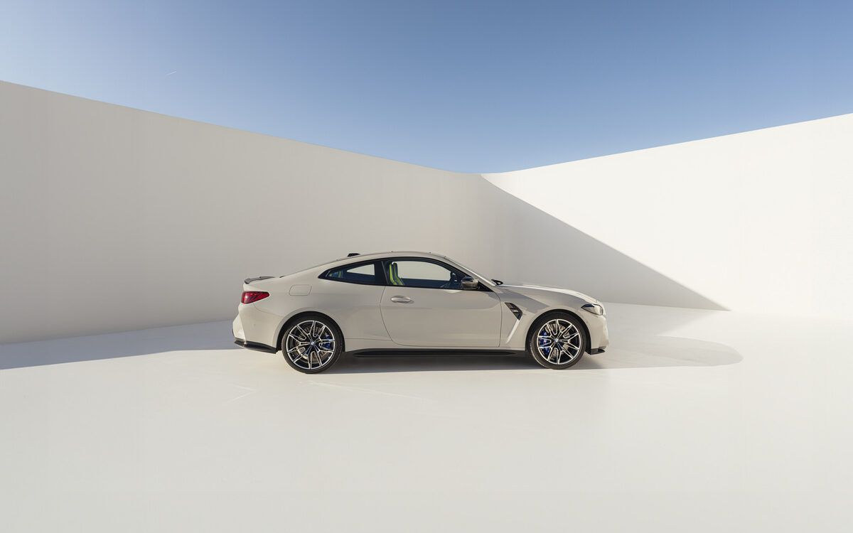 BMW M4 Competition in a studio setting, side profile