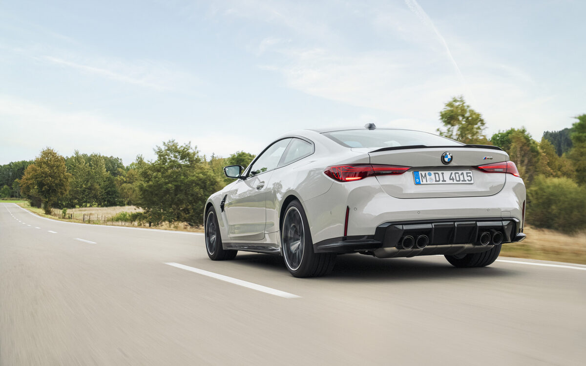 BMW M4 Competition on the road, rear three-quarter view