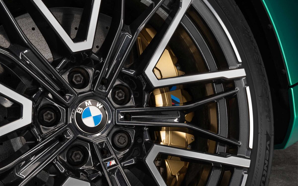 Close-up of the BMW M5 alloy wheel with gold brake caliper