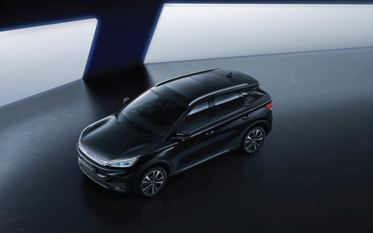 BYD Atto 3 in black seen from above and the front in a dark studio