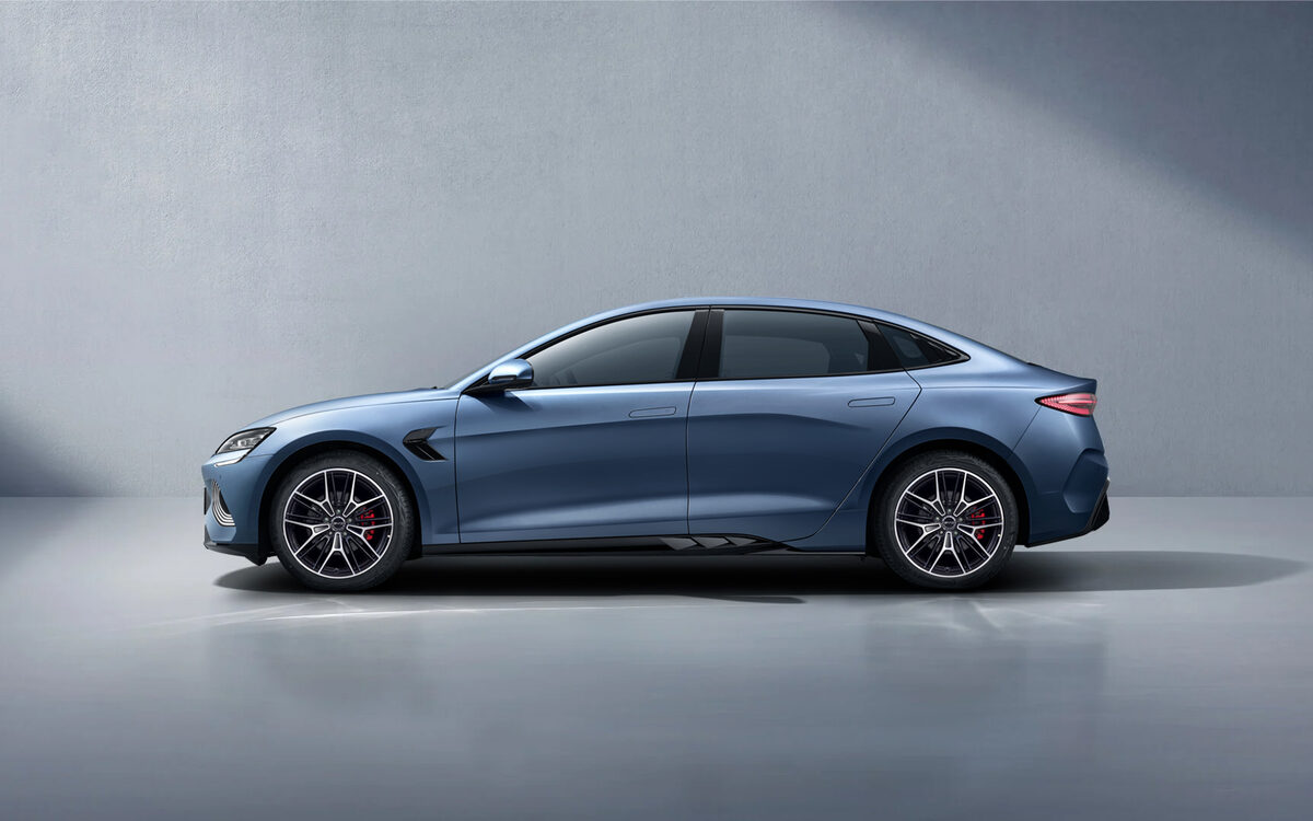 BYD Seal in blue-grey, side profile against a grey studio wall