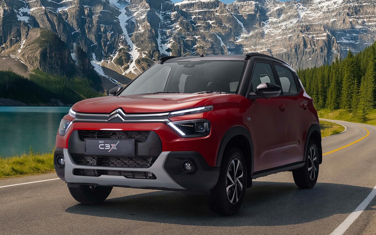 Citroen C3 in Garnet Red, front three-quarter view on a mountain lake road