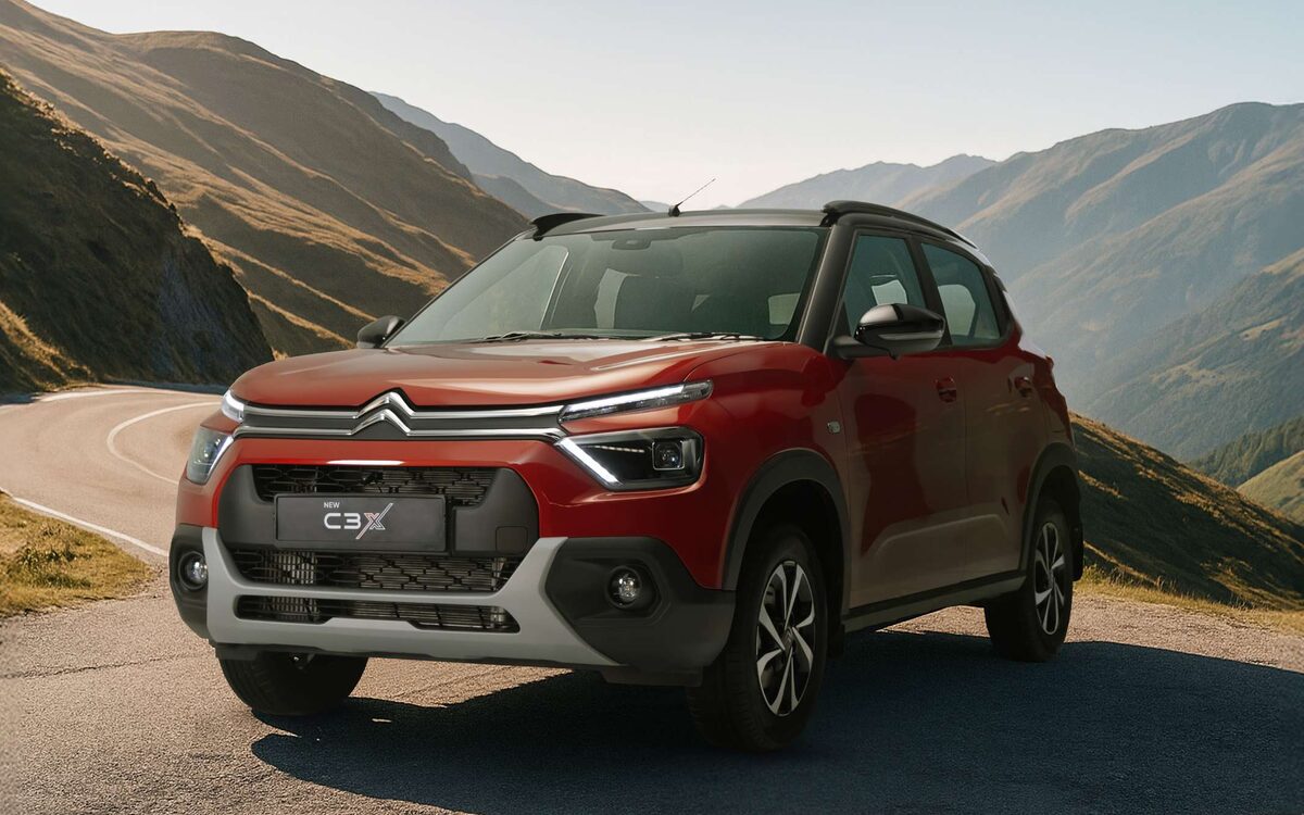 Citroen C3 in red, front view on a winding hill road