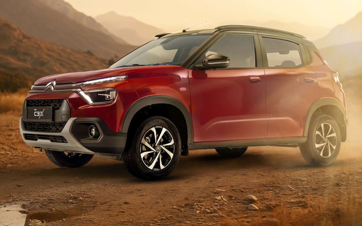 Citroen C3 in red on rocky ground in warm sunset light