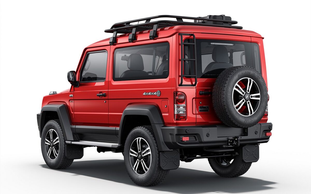 Force Gurkha 3-door in red, rear three-quarter view with the spare wheel on the tailgate