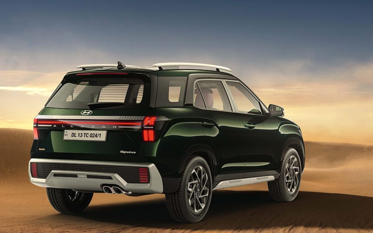 Hyundai Alcazar in black, rear three-quarter view with the connected tail lamps and twin exhaust tips