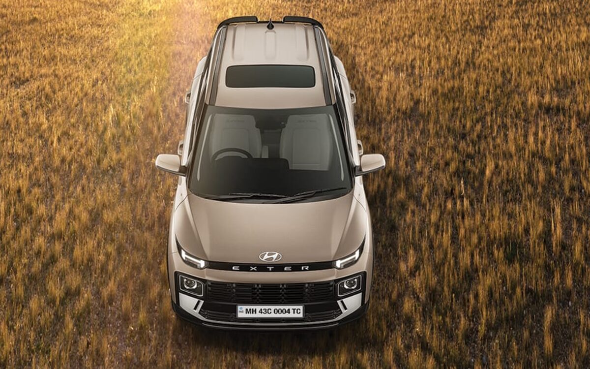 Hyundai Exter from above, driving through a golden grass field