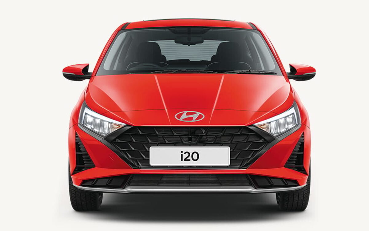 Hyundai i20 in red, straight-on front view showing the parametric grille and LED headlamps