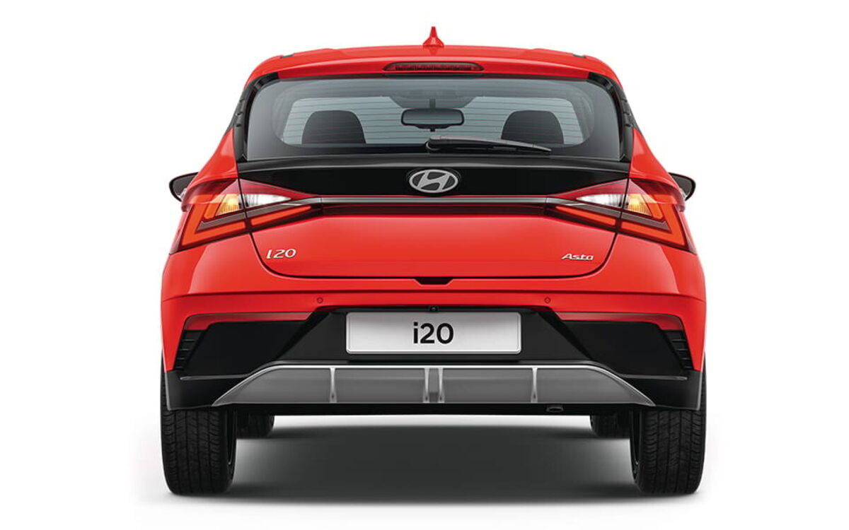 Hyundai i20 in red, straight-on rear view showing the tail lamps, tailgate and skid-plate style bumper