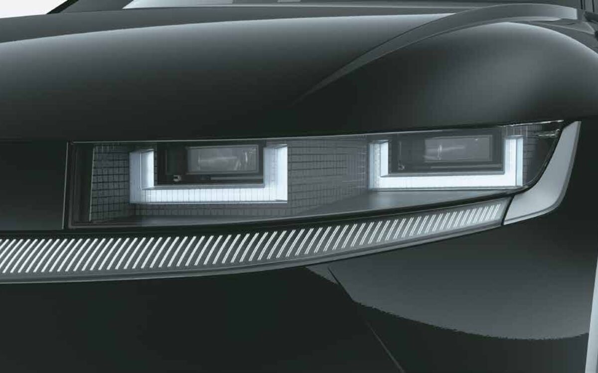 Close-up of the IONIQ 5 front LED headlamps and daytime running lights