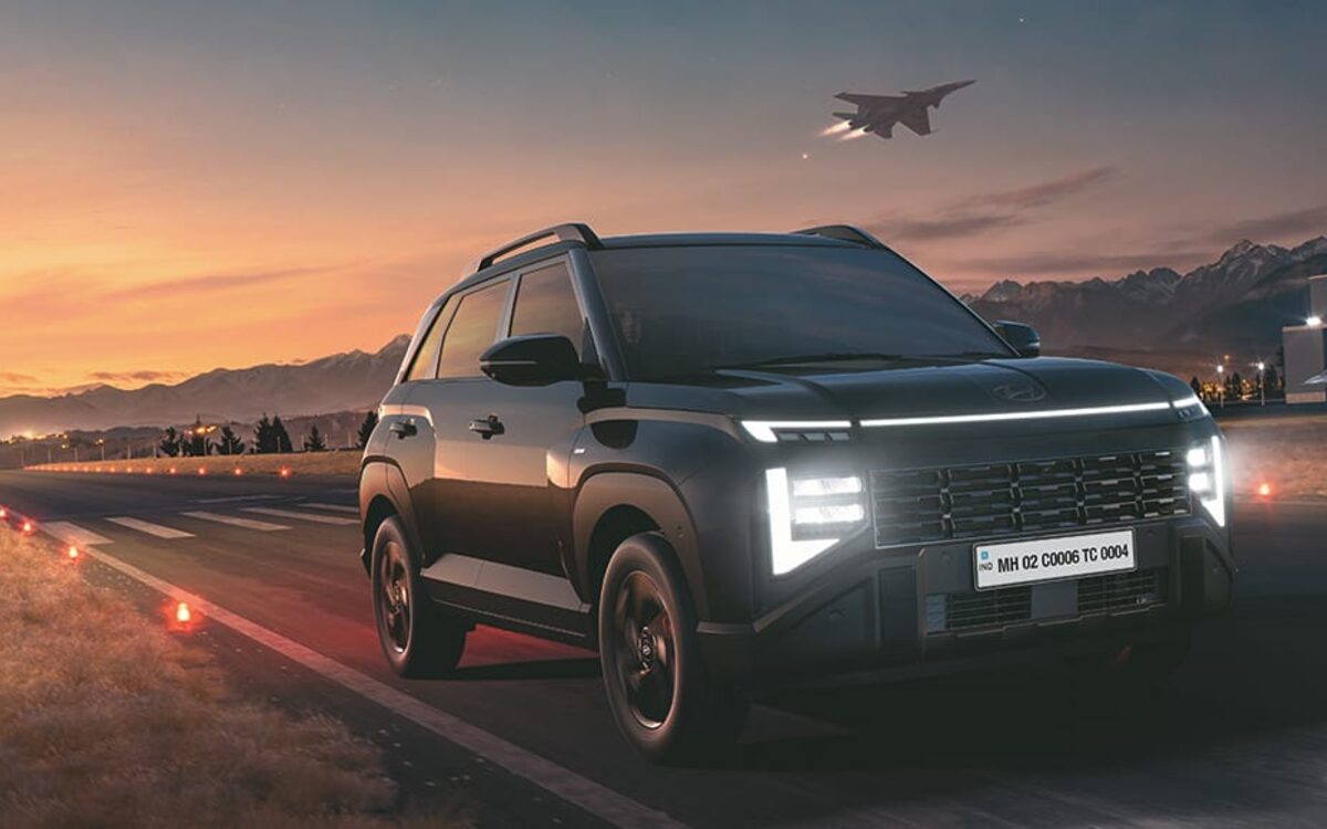 Hyundai Venue Knight Edition in black with lit light bar on a runway at dusk