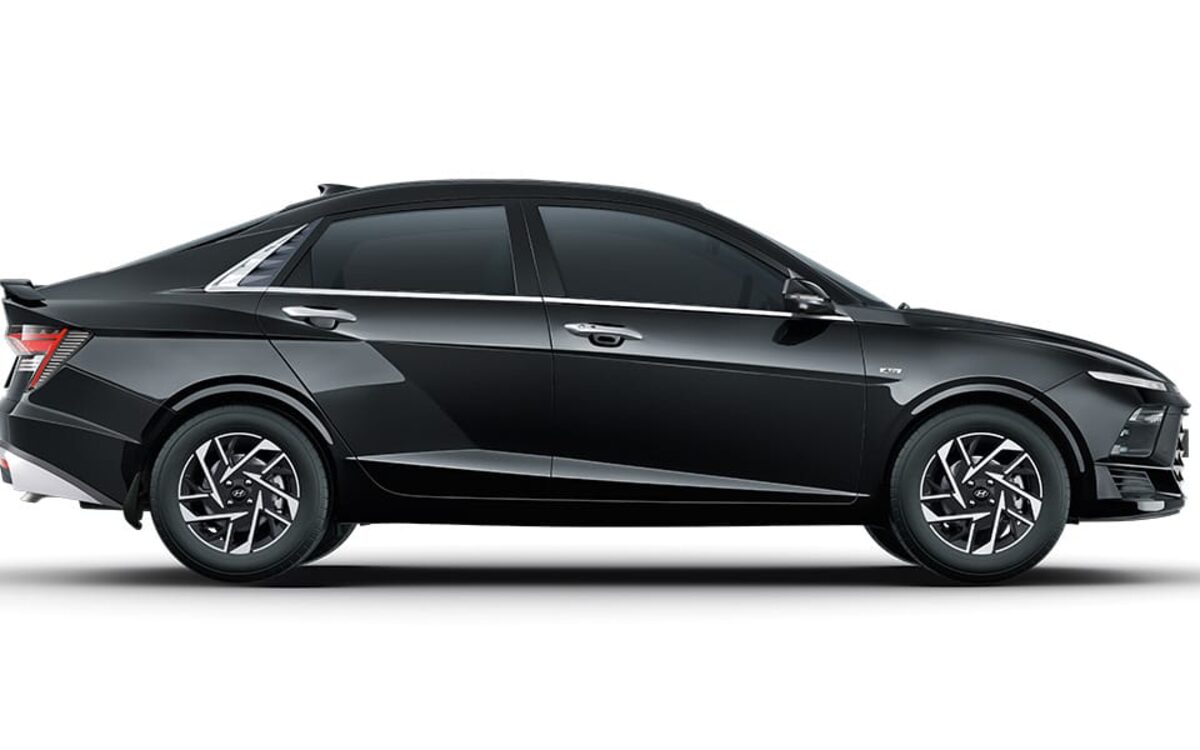 Hyundai Verna in black, side profile showing the coupe-like roofline and alloy wheels on a white background