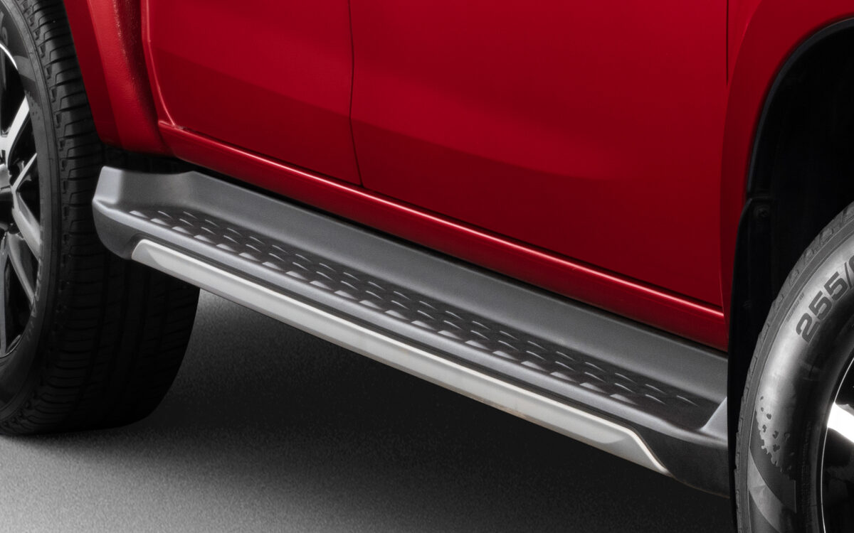 Close-up of the silver side step and front wheel arch on a red Isuzu D-MAX V-Cross
