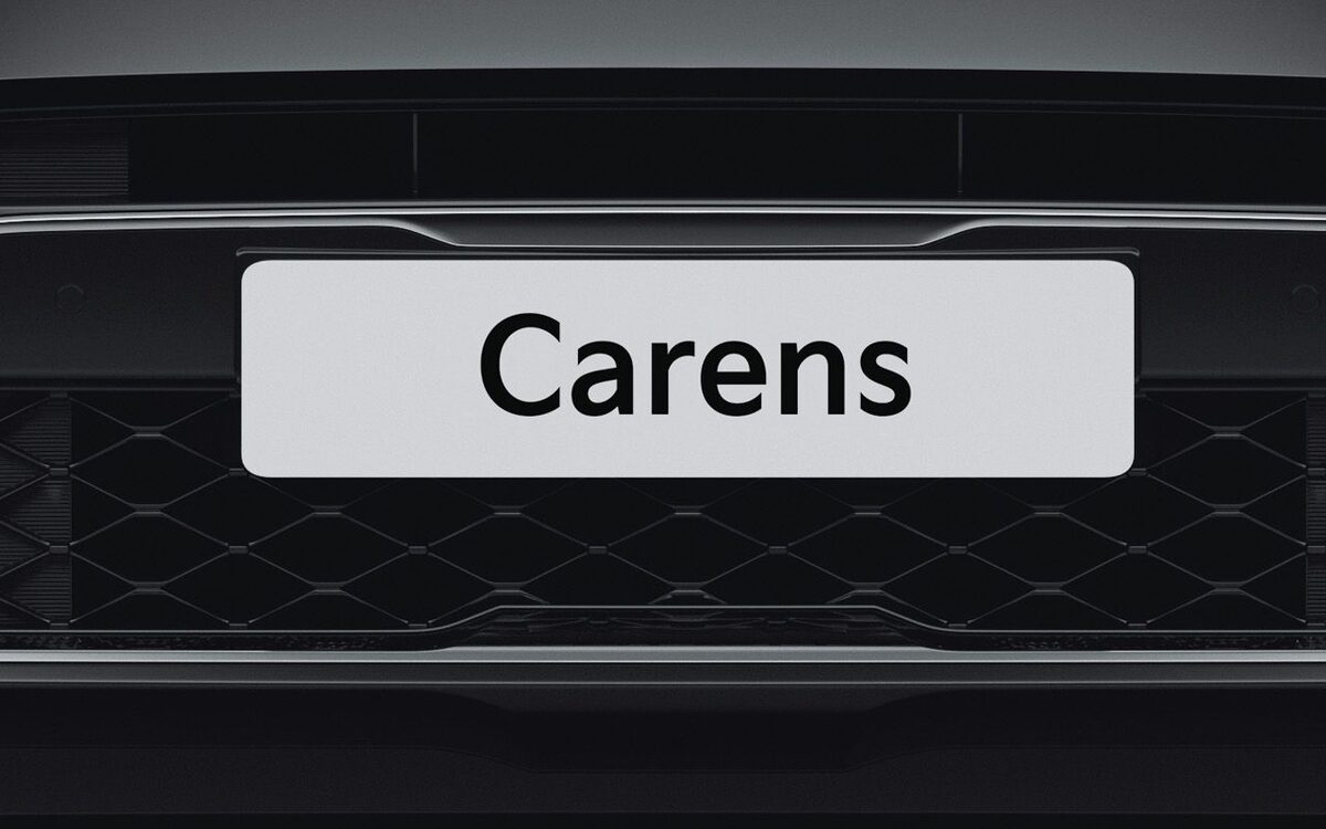 Close-up of the Kia Carens front grille and LED daytime running lights