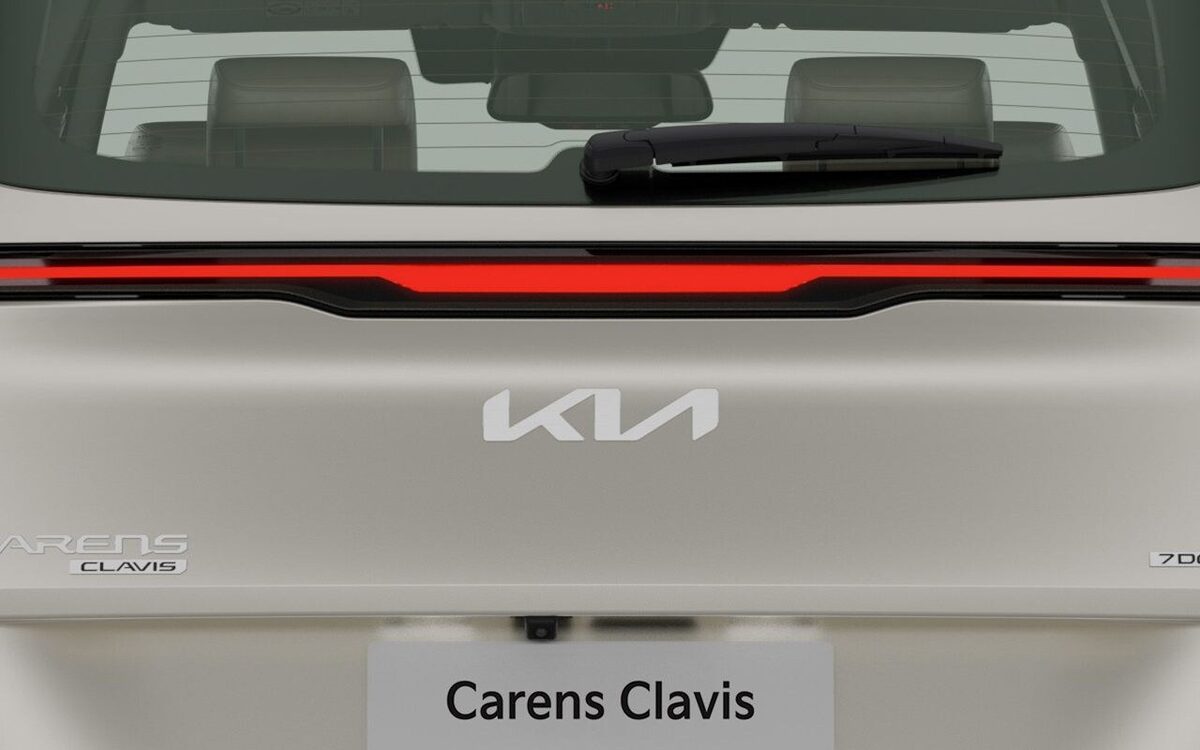 Rear of the Kia Carens Clavis showing the connected LED tail lamp bar and Kia badge
