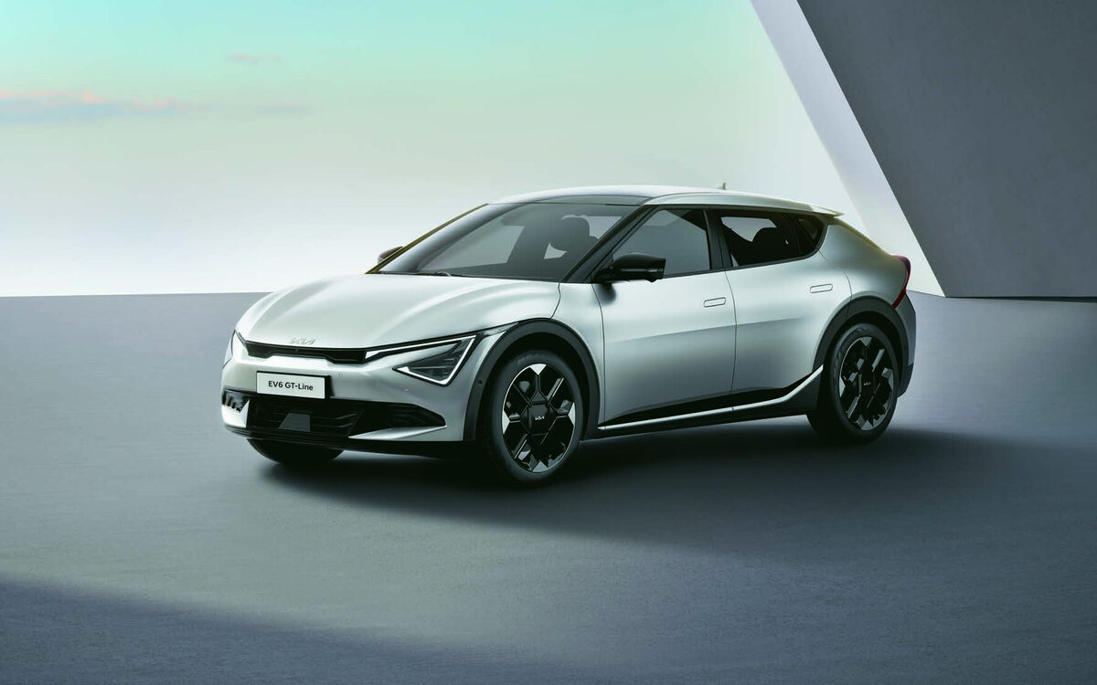 Kia EV6 GT-line in silver, front three-quarter view in a bright concrete studio set