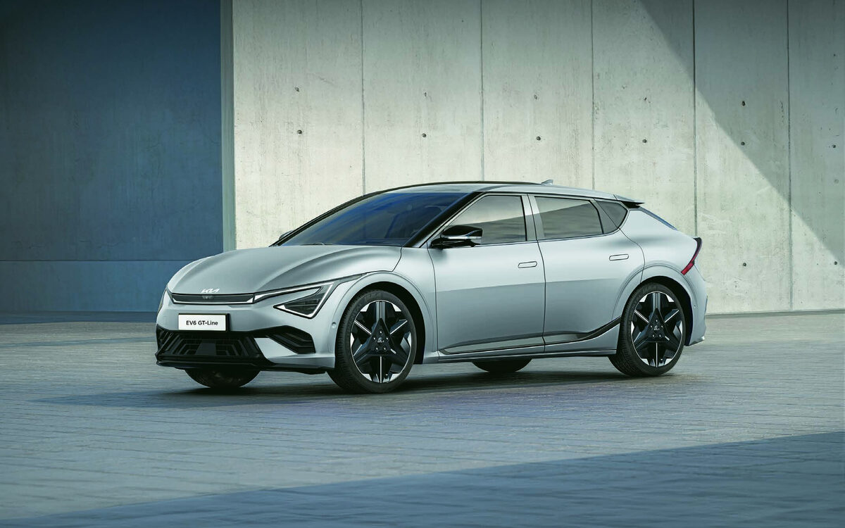 Kia EV6 GT-line in silver parked in a concrete courtyard, front three-quarter view