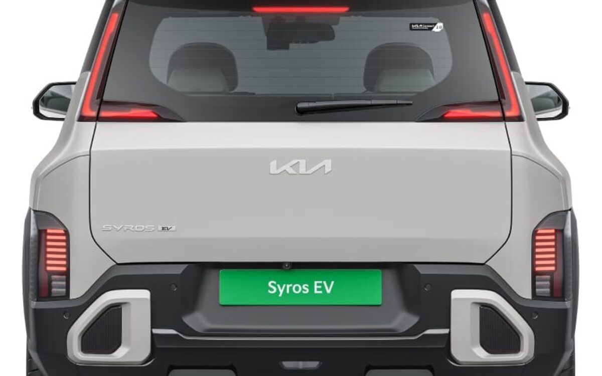 Kia Syros EV in silver seen straight from the rear with the tail lamps and rear bumper
