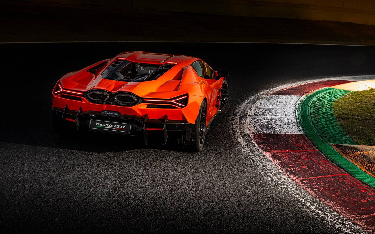 Lamborghini Revuelto in orange, seen from behind on a race track