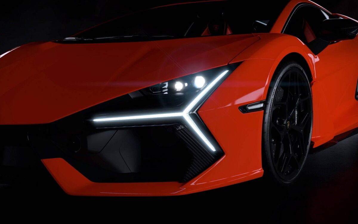 Lamborghini Revuelto front end close-up in orange showing the Y-shaped LED daytime running light