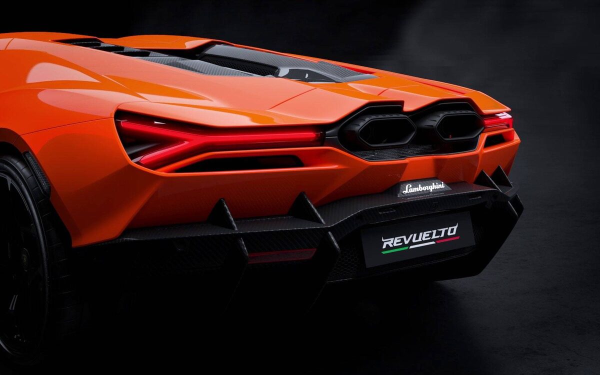 Lamborghini Revuelto rear close-up in orange showing the tail lamp, twin exhausts and diffuser