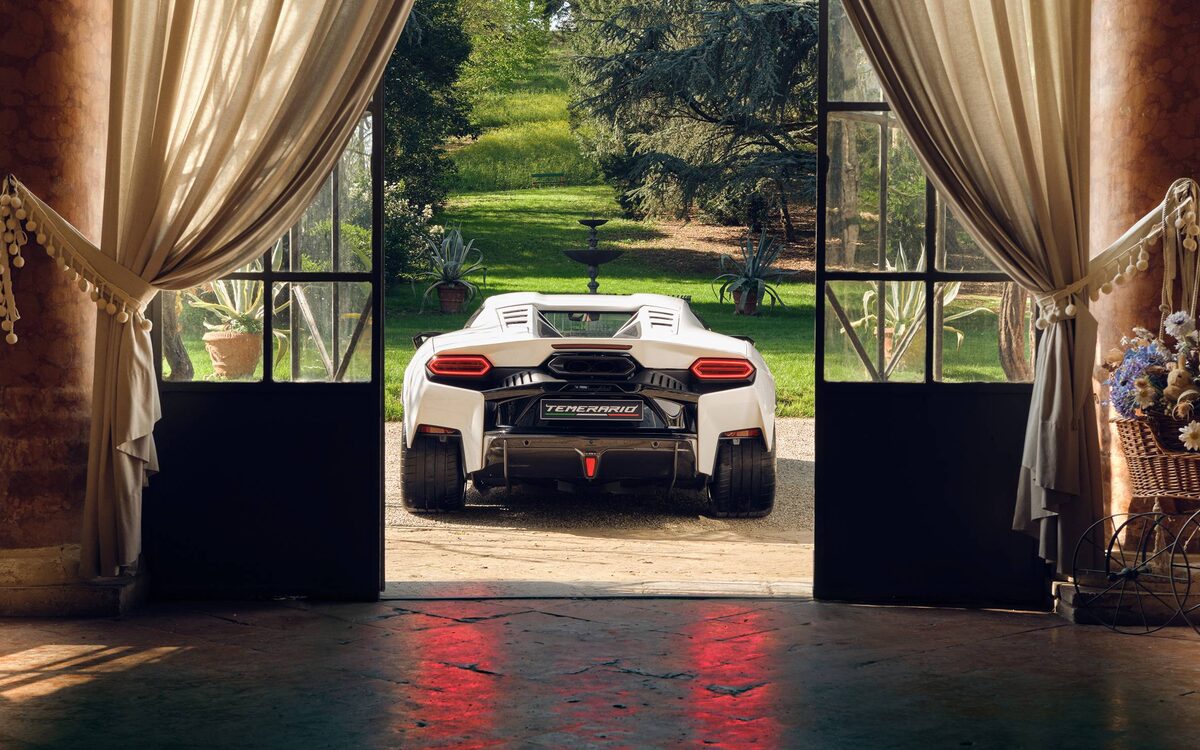 Lamborghini Temerario in white seen from behind through open doors of a building