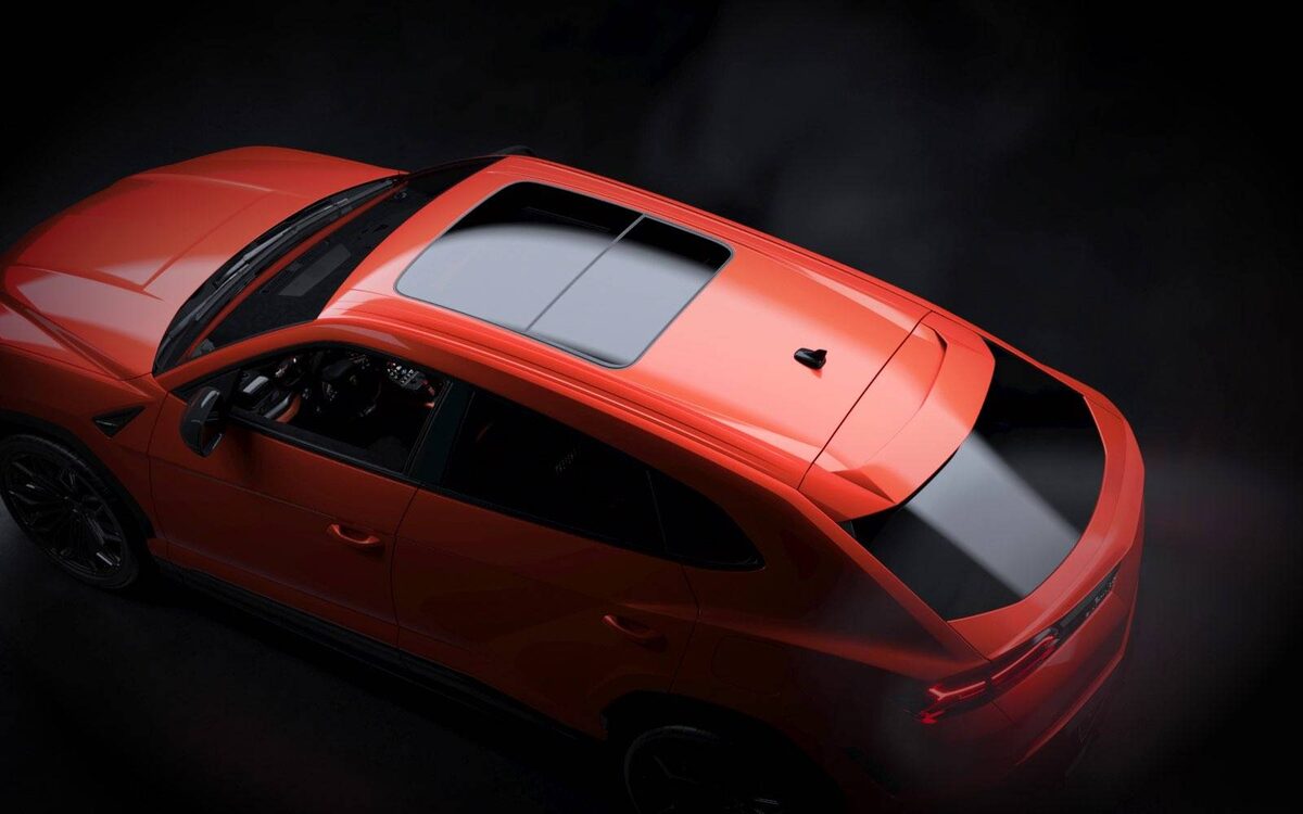 Lamborghini Urus SE in orange, seen from above showing the glass roof and black rear roof section