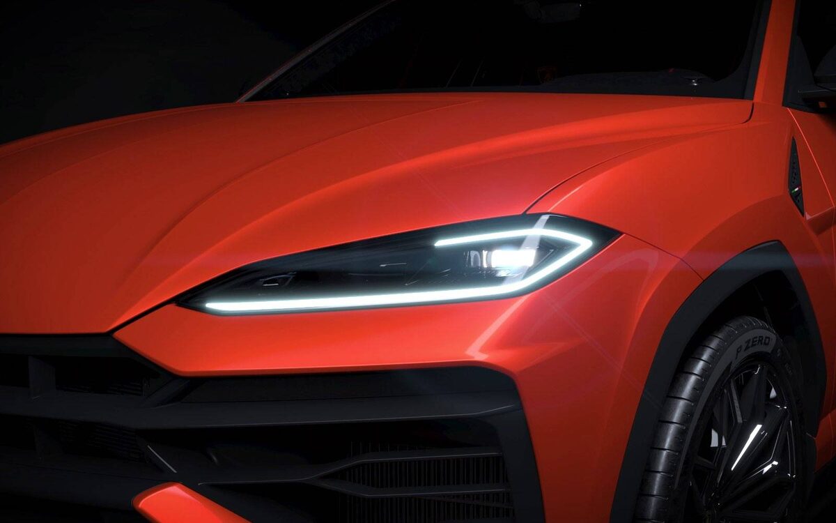 Lamborghini Urus SE front close-up in orange showing the slim LED headlamp