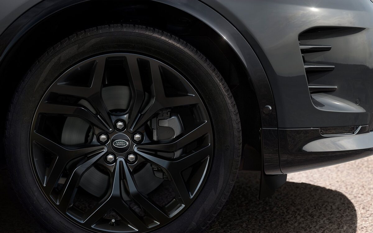 Close-up of the Land Rover Discovery Sport black alloy wheel and front wheel-arch vents
