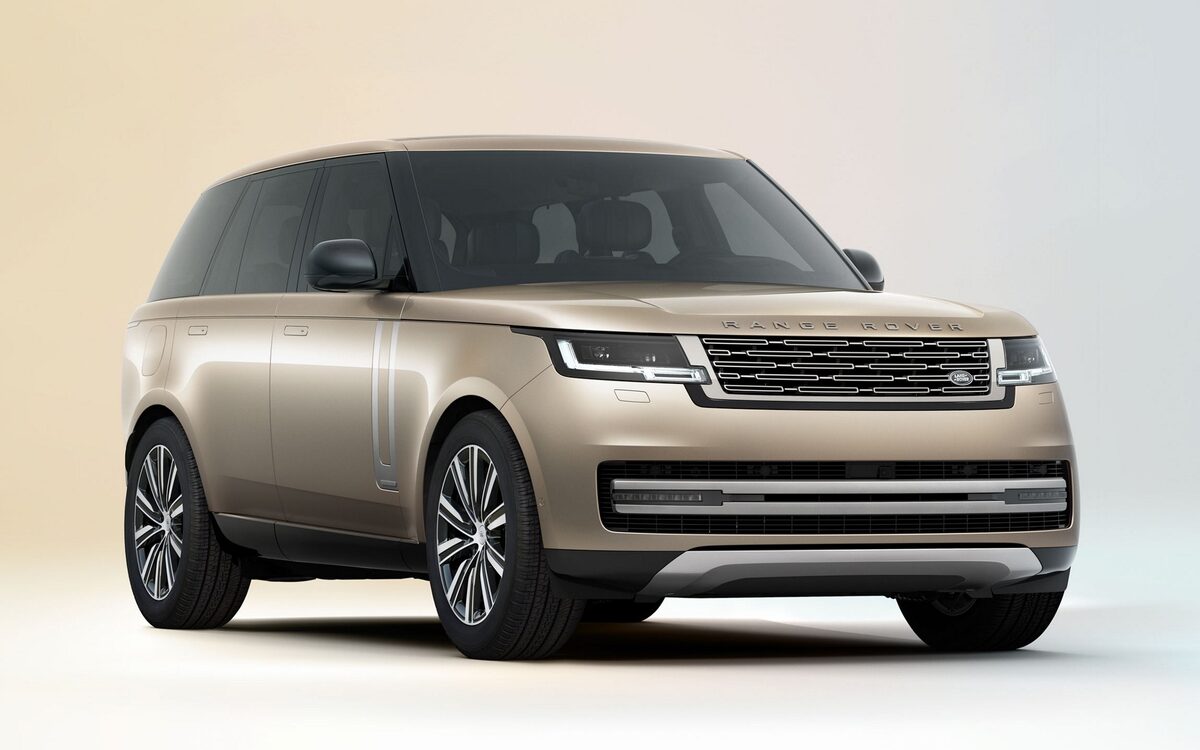 Range Rover in champagne gold on a plain studio background, front three-quarter view