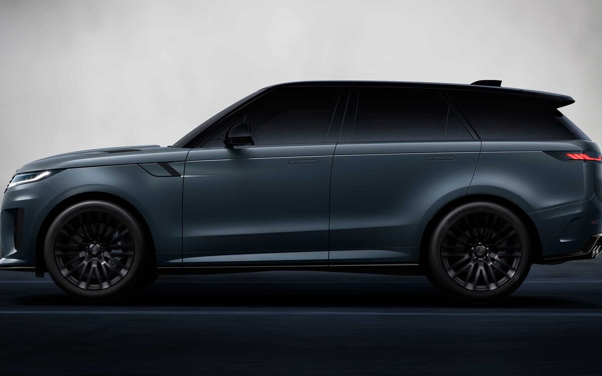 Range Rover Sport in dark grey, full side profile in a studio-style setting