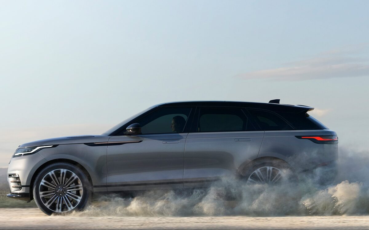 Range Rover Velar driving along a dusty open road, side view