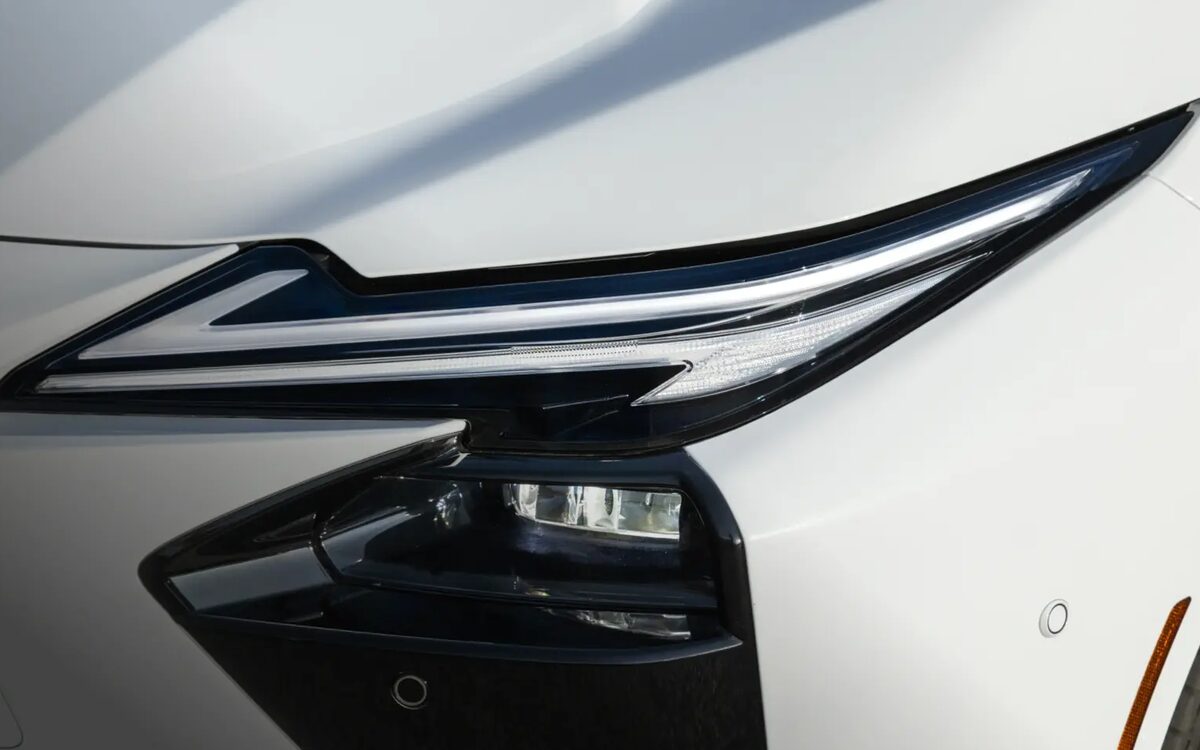 Close-up of the Lexus ES twin L-signature LED headlamp on a white car