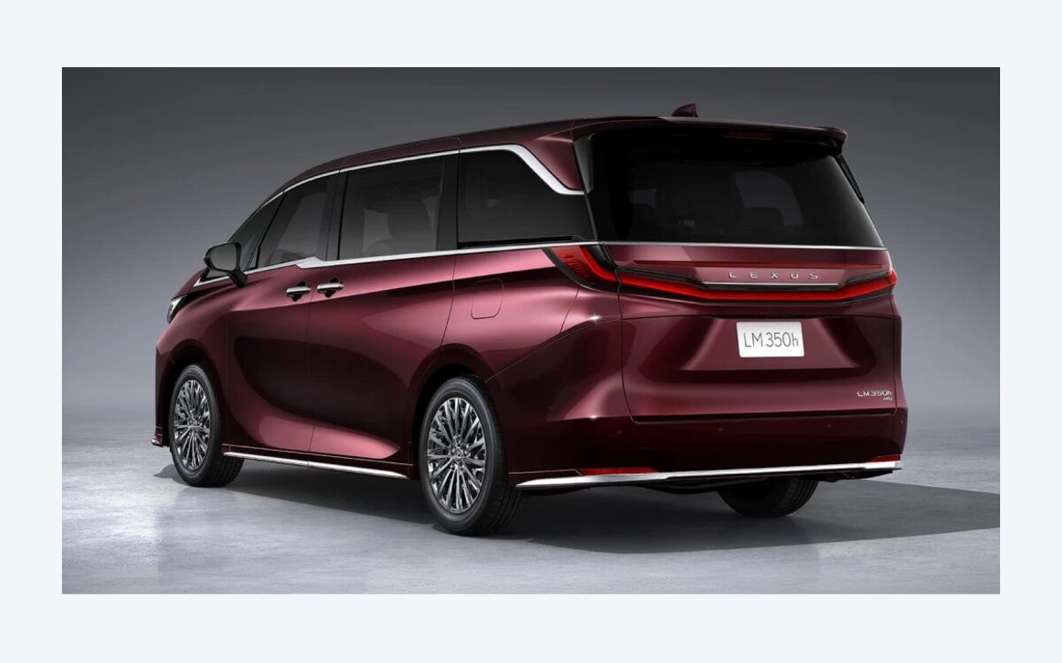 Maroon Lexus LM 350h seen from the rear three-quarter with the full-width tail lamp