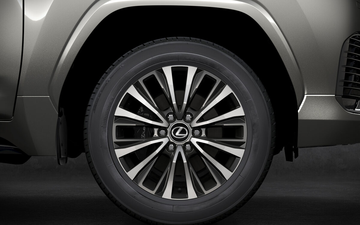 Close-up of a Lexus LX alloy wheel and wheel arch in a dark studio