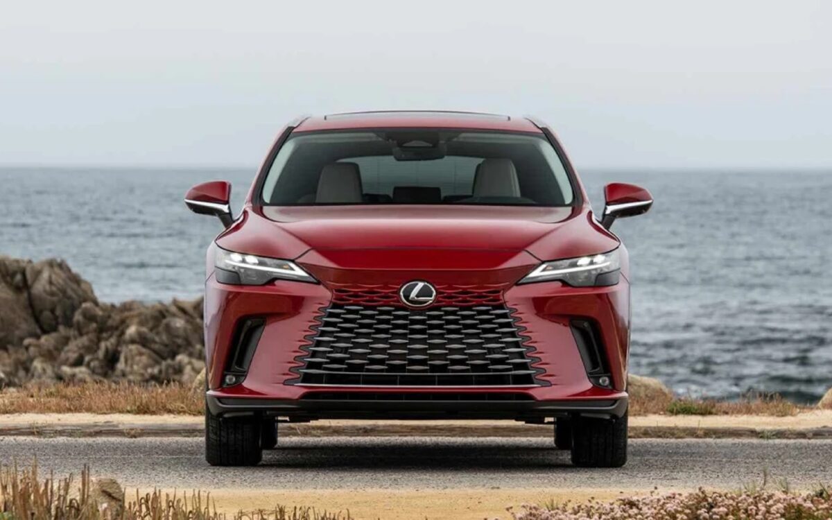 Red Lexus RX 350h seen head-on on a seaside road