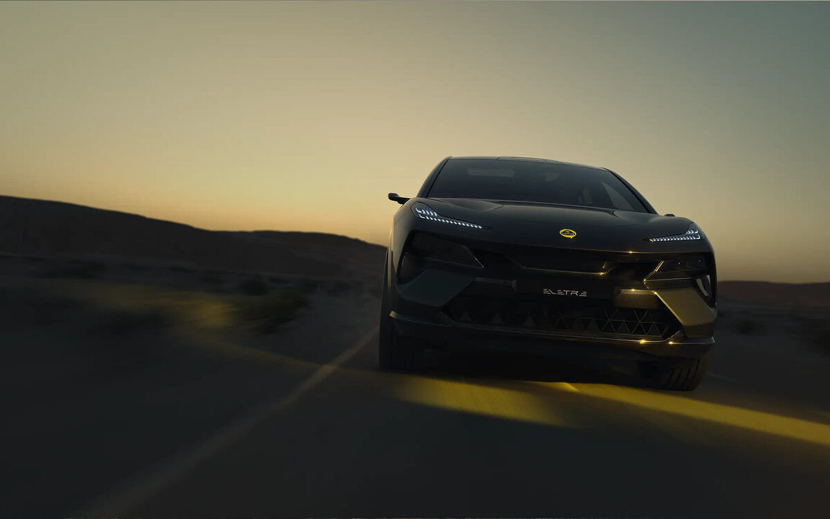 Lotus Eletre in black, head-on front view at dusk on a desert road