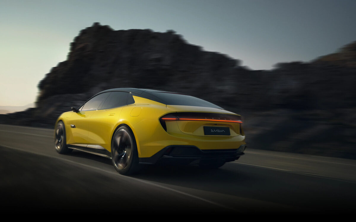 Lotus Emeya in yellow, rear three-quarter view driving past rocks