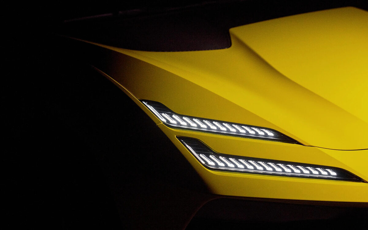 Close-up of the Lotus Emeya LED headlamps on a yellow car